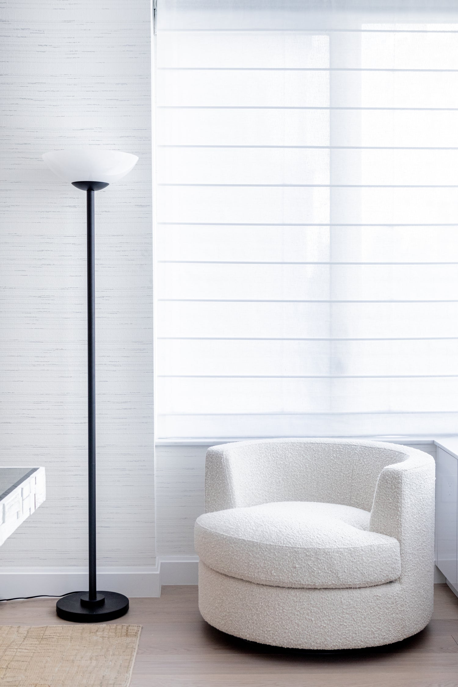 Contemporary black lamp next to comfy chair in living room