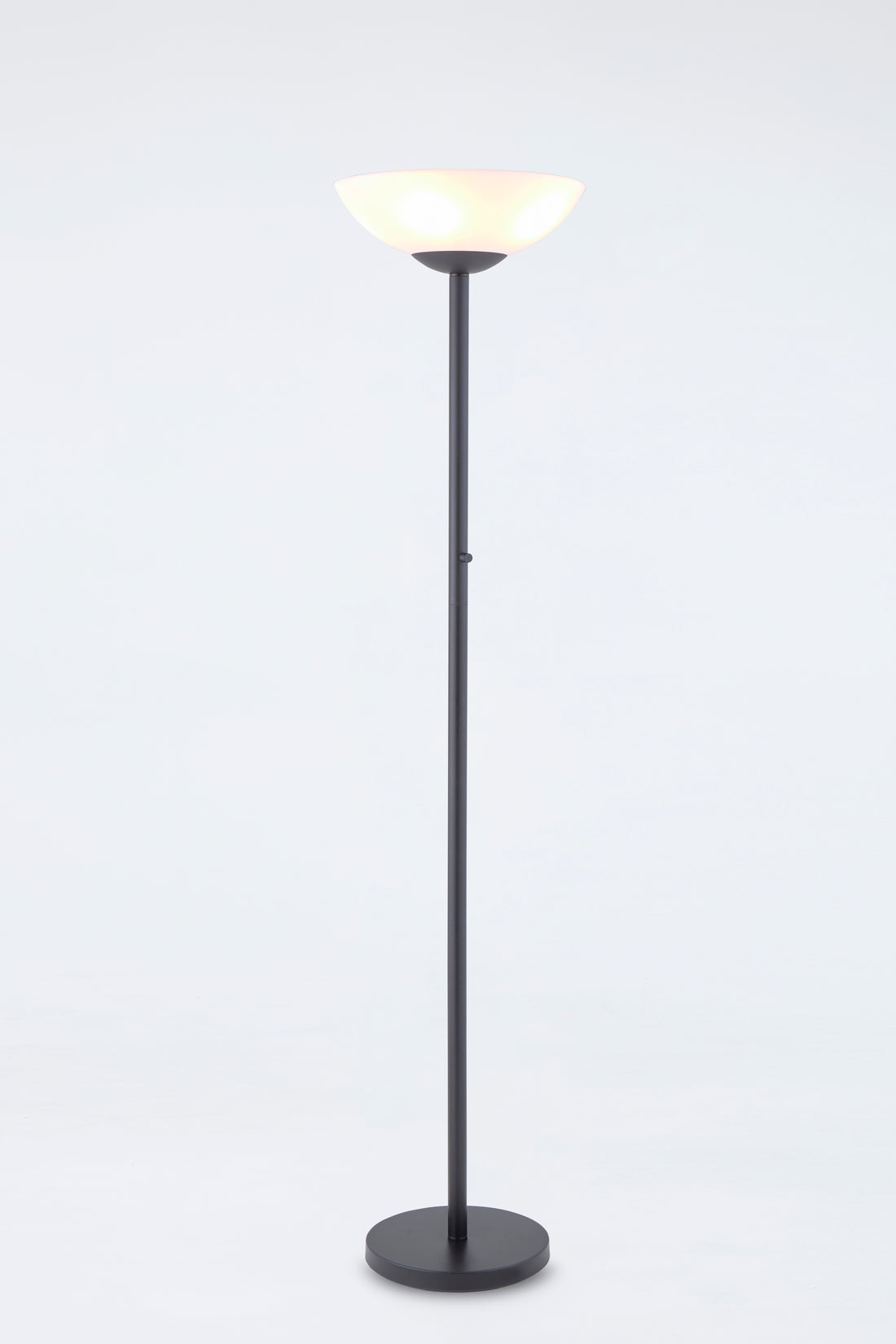 Floor lamp with a black base and white shade on a light gray background