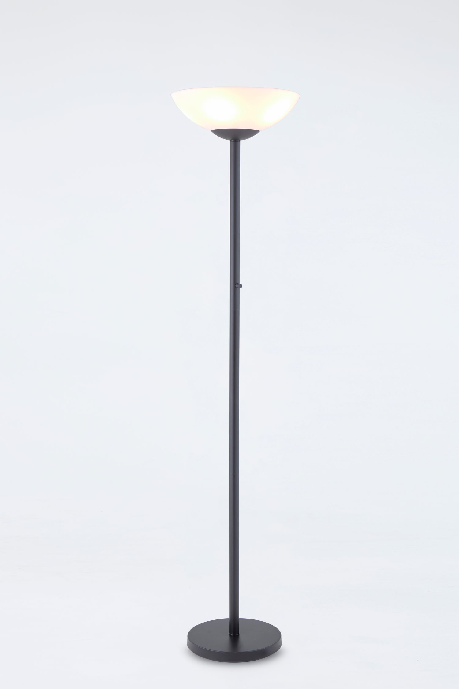 Floor lamp with a black base and white shade on a light gray background